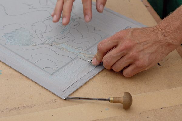 Preparing a linocut design.