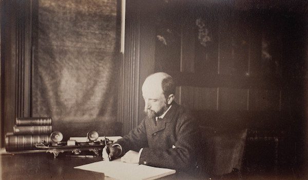 Henry Adams seated at his desk, 1883.