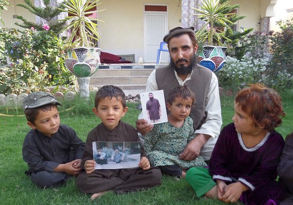 Fazel Karim holds a picture of his brother, who was recently released from the Guantanamo Bay detention center.