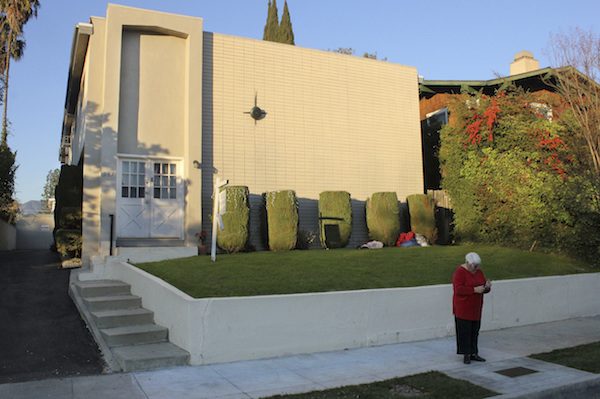 A woman takes a picture of the plaque in front of the Pasadena residence where Barack Obama lived during his sophomore year at Occidental College. Photo by John Antczak/Associated Press.