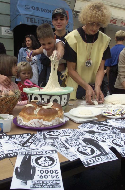 Serbian children play with flour around an activist of the anti-government group Otpor, or Resistance, during a protest action entitled "Let’s spice up the food," meant to bring awareness of the importance of Yugoslav national elections in September 2000 in Belgrade. Photo by Darko Vojinovic/Associated Press.