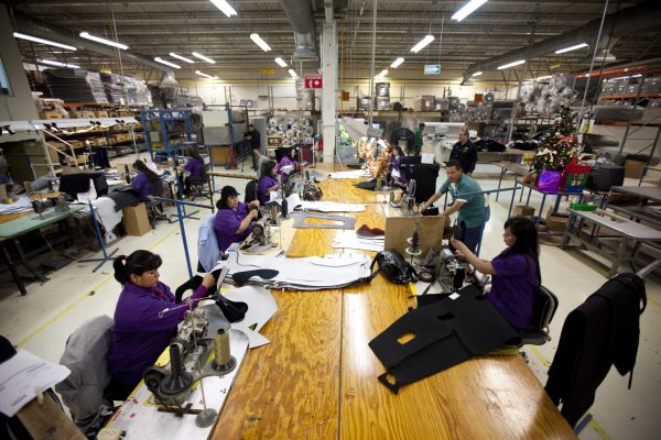 Workers manufacture car dash mats at a maquiladora belonging to the TECMA group in Ciudad Juarez, Mexico, Dec. 27, 2013. Photo by Ivan Pierre Aguirre/Associated Press.