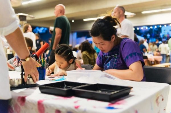 Vistors enjoy “Friday Nights @ OMCA,” a program of the Oakland Museum of California, during the exhibition “All Power to the People: Black Panthers at 50.” Photo courtesy of the Oakland Museum of California.