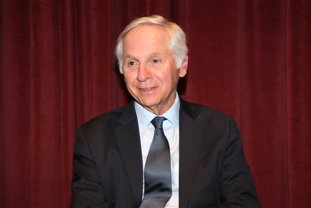 Mark Baldassare in a black suit and tie staring slightly to the left with a small smile.