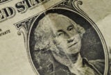 A close up of George Washington on the dollar bill, which is slightly creased.